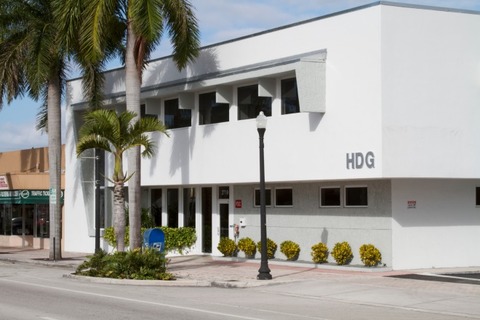 a building that has a sign on the side of a road