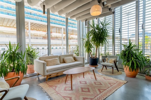 a living room filled with furniture and a large window