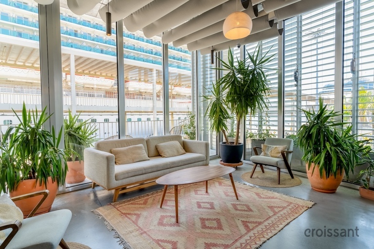 a living room filled with furniture and a large window