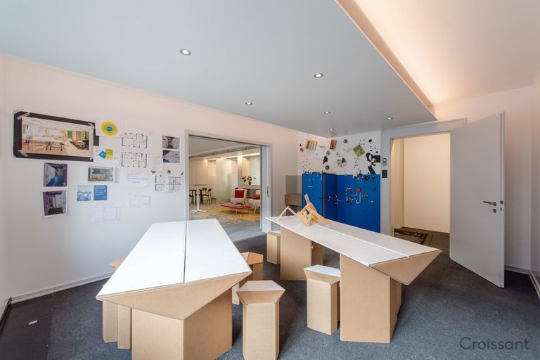 a kitchen with a refrigerator and table in a room