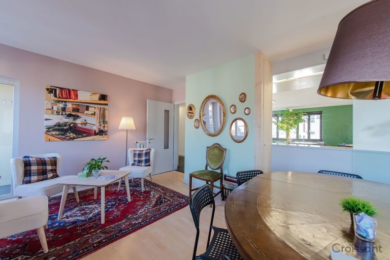 a view of a living room filled with furniture and a lamp