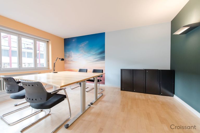 a kitchen with a wood floor in a room