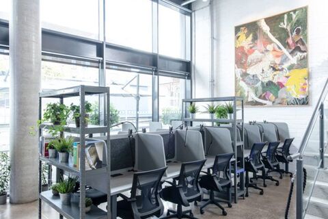 a room with a desk and chairs
