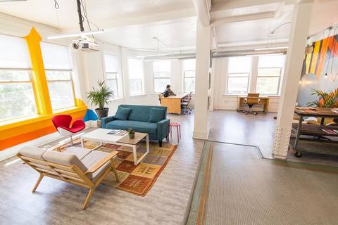 a living room filled with furniture and a large window