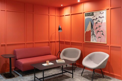 a room with red walls and a couch and a table