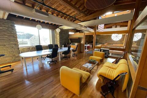 a room filled with furniture next to a building
