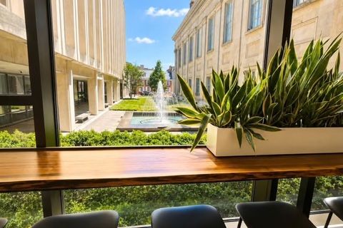 a window with a planter and chairs
