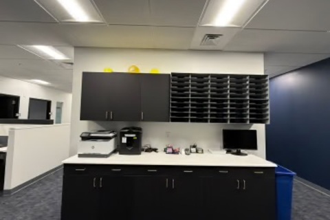 a room with black cabinets and a printer