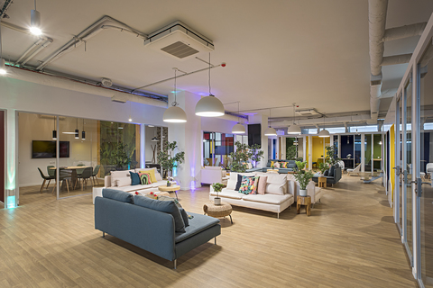 a room filled with furniture next to a building