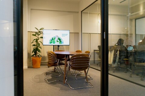 a kitchen with a table and chairs in a room