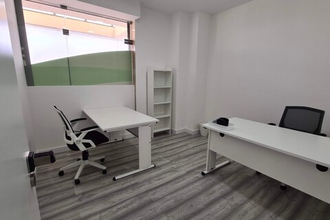 a bedroom with a bed and desk in a room