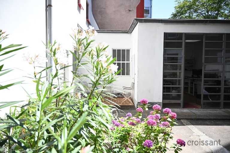 a close up of a flower garden in front of a house