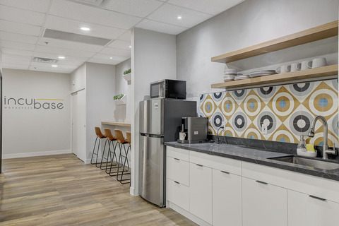 a kitchen area with a building in the background