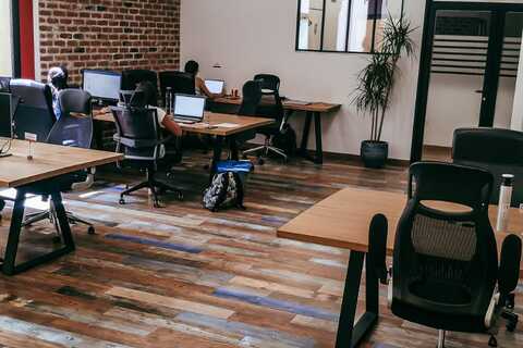 a room with many computers and a brick wall