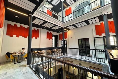 a man sitting at a table in a building