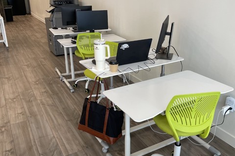 a laptop computer sitting on top of a wooden floor