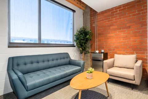 a brown leather couch in a living room