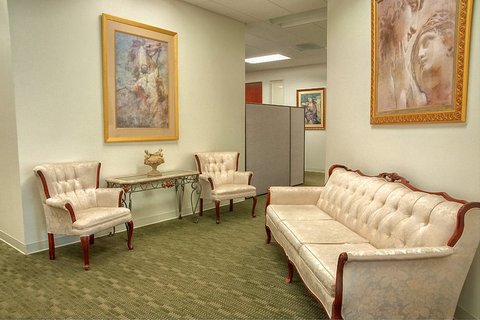 a living room filled with furniture and a painting on the wall