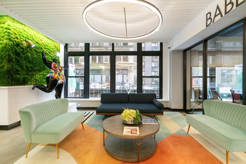 a living room filled with furniture and a large window