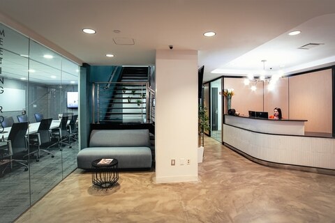 a living room filled with furniture and a large window