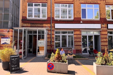 a bench in front of a brick building