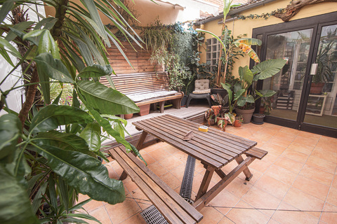 a patio with benches and plants
