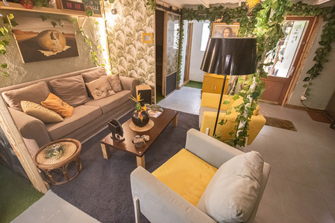a living room with couches and a lamp