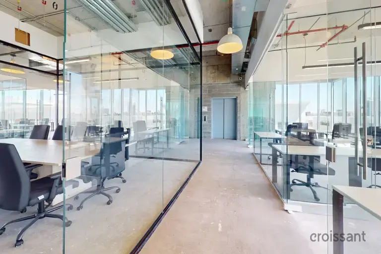 a glass wall with a group of tables and chairs
