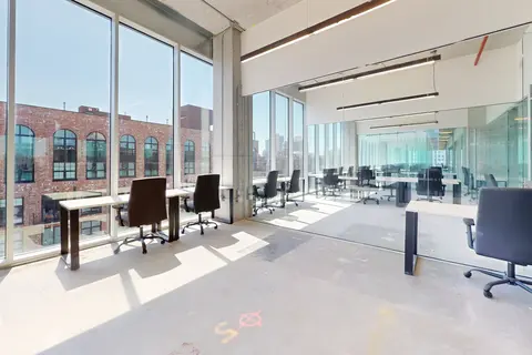 a room with a glass wall and chairs