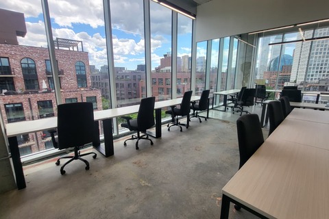 a room with a table and chairs and a window with city view