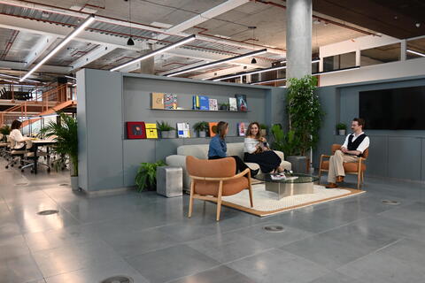 a room filled with furniture next to a building