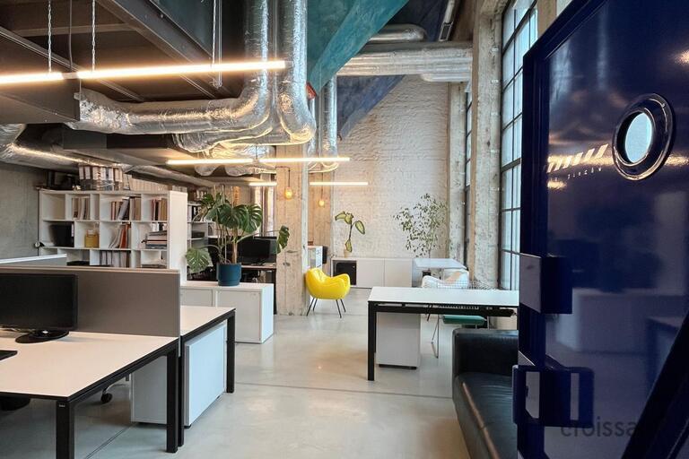 a room with a blue door and white tables and a yellow chair