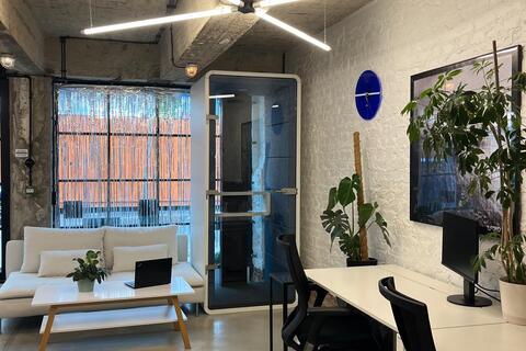 a room with a white couch and a white desk