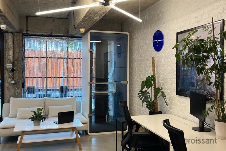 a room with a white couch and a white desk