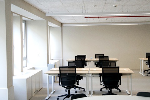 an office with a desk and chair in a room