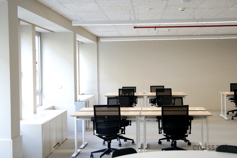 an office with a desk and chair in a room