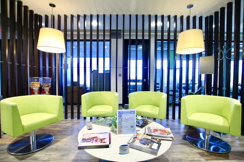 a living room filled with furniture and a blue chair