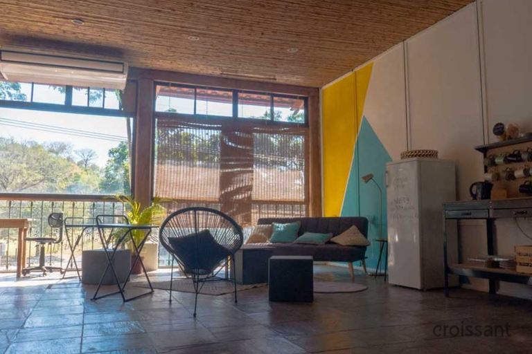 a living room filled with furniture and a large window