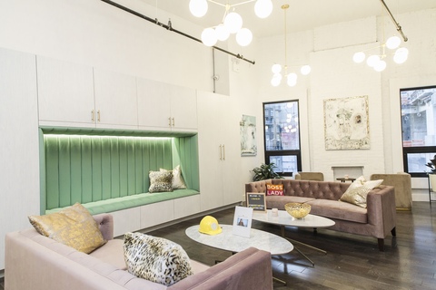a living room filled with furniture and a mirror