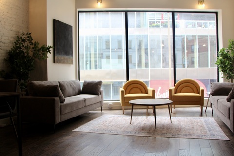 a living room filled with furniture and a large window