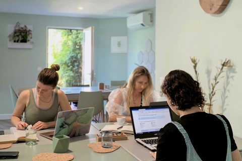a group of people sitting at a table with a laptop