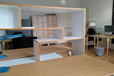a bedroom with a bed and desk in a room