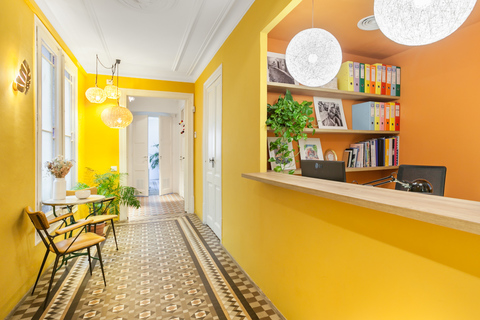 a room with yellow walls and a large window