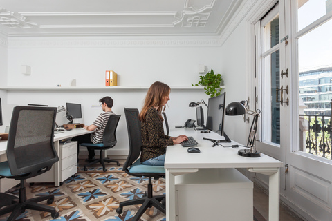 a person sitting at a desk in a room