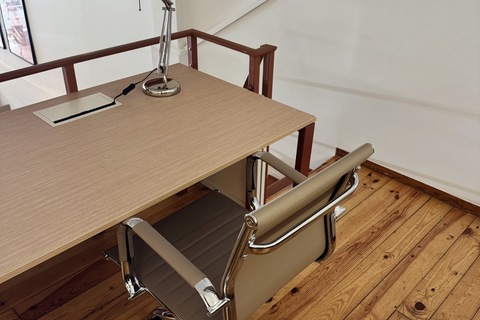 a desk with a lamp and a chair
