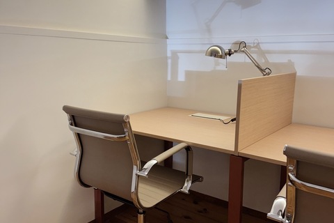 a desk with a lamp and a desk