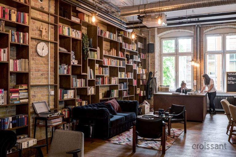 a living room filled with furniture and a book shelf