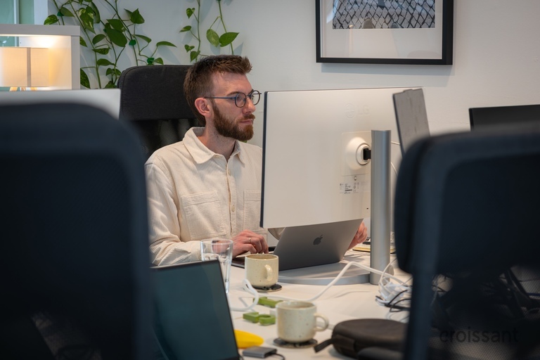 a man sitting at a desk with a computer