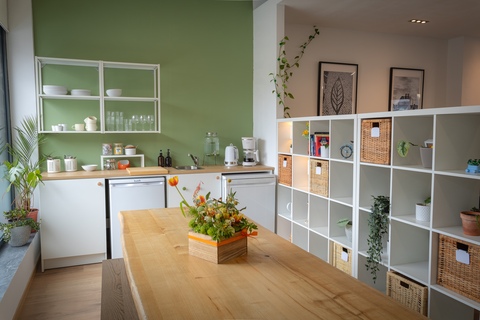 a kitchen with white cabinets and a wooden table