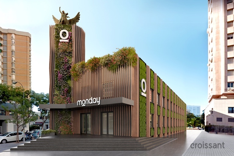 a building with a clock on the side of a road